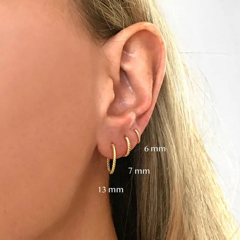 Sterling silver twisted round ring earrings in gold or white gold finish, shown in 6mm, 7mm, 8mm, and 13mm sizes.