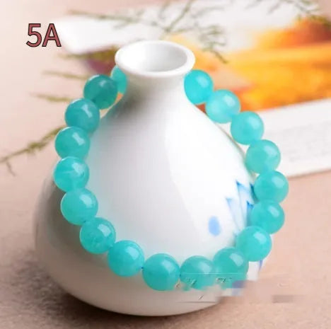Natural blue-green Amazonite scattered bead bracelet on a wrist, showing polished stone beads in an original design.