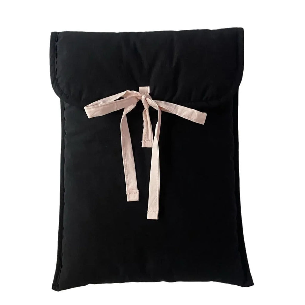 Black and white quilted laptop bag with a large ballet-style bow on the front.