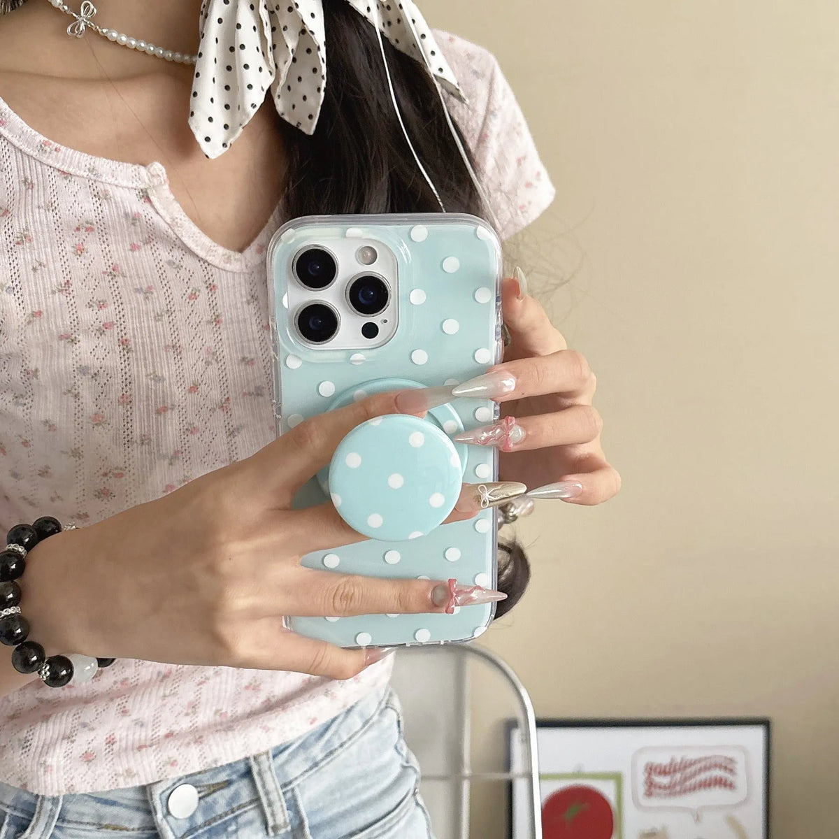 Polka dot iPhone case with magnetic bracket in black, pink, blue, and purple, compatible with iPhone models.