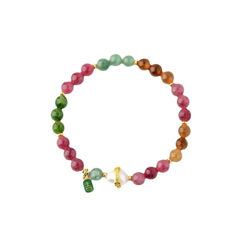 Geometric chalcedony crystal bracelet with 6.5mm beads on a wrist.