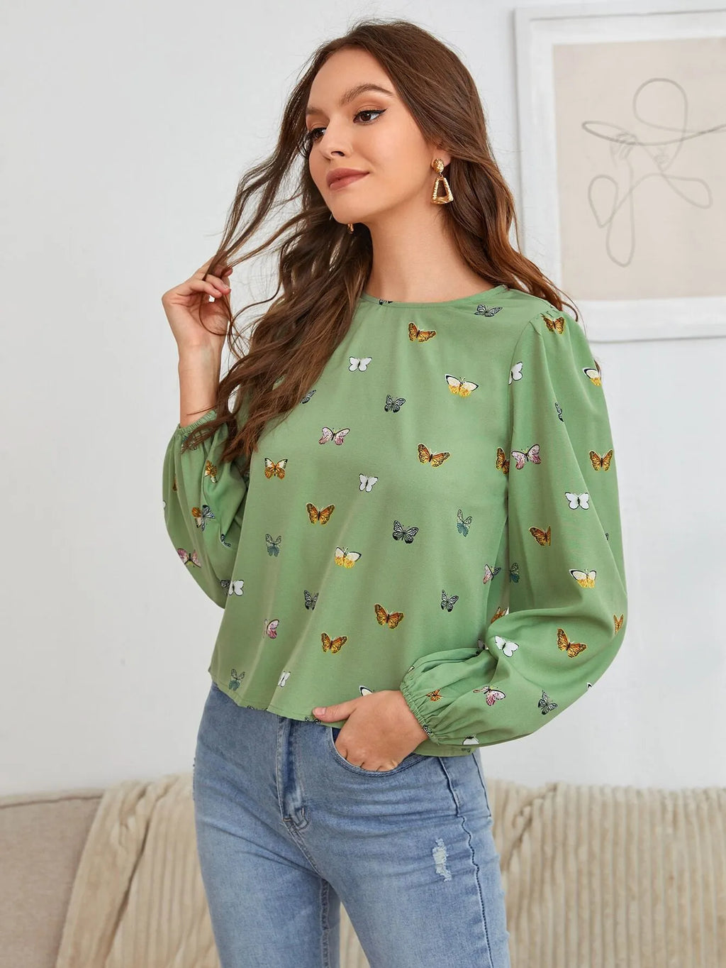 Women's green long-sleeved shirt with butterfly print pattern and loose fit.