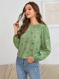 Women's green long-sleeved shirt with butterfly print pattern and loose fit.