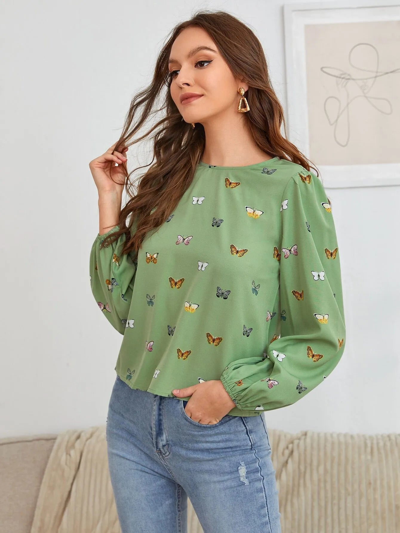 Women's green long-sleeved shirt with butterfly print pattern and loose fit.