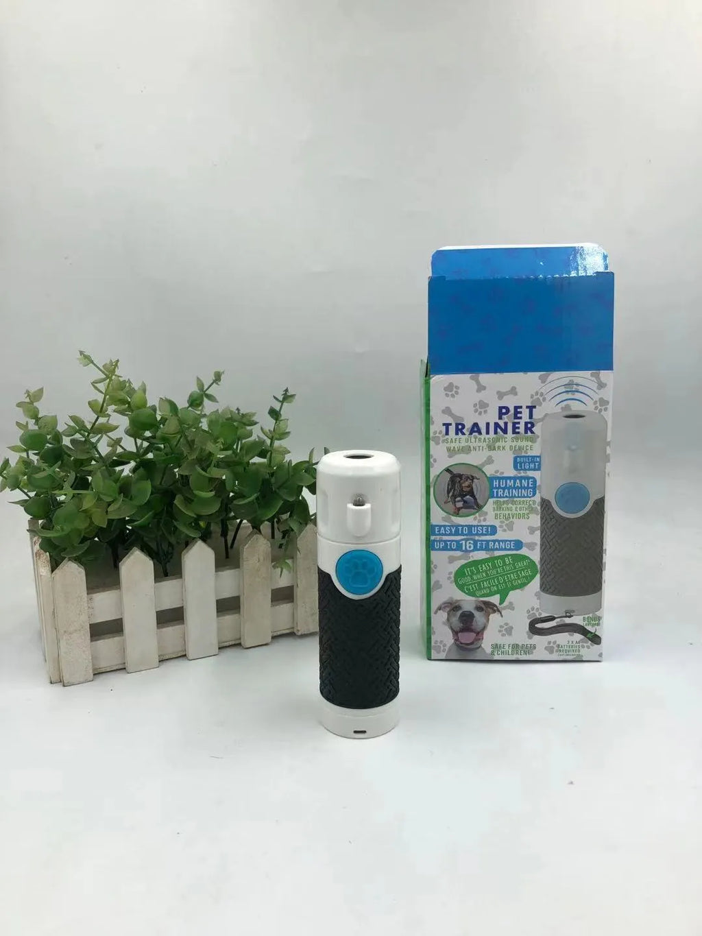 White handheld ultrasonic dog trainer device with LED light for bark control and behaviour correction