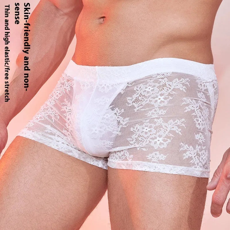 Men's black lace boxer shorts made from nylon fabric, laid flat to show front lace panel design.