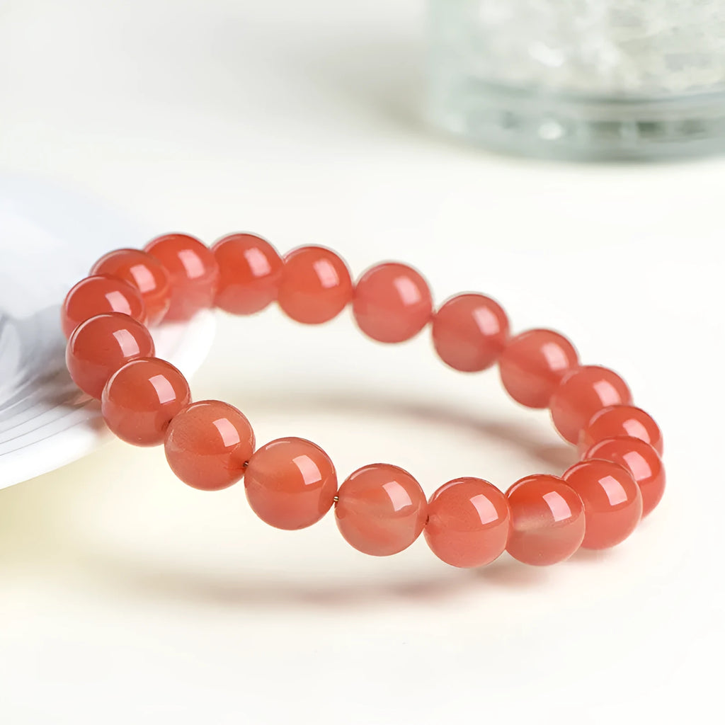 Polished South cherry red agate scattered bead bracelet shown in single and triple circle styles.