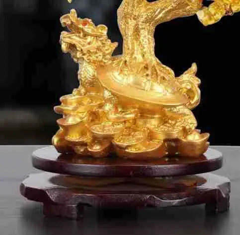 Citrine-coloured resin Feng Shui ornament of a small turtle on a money tree.