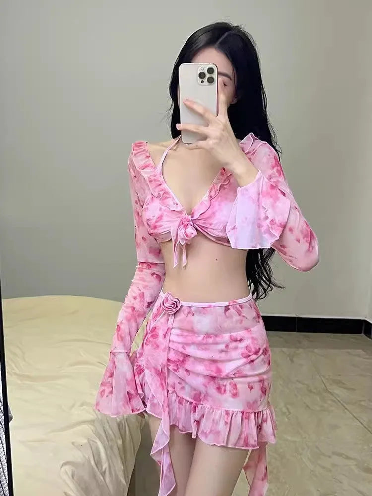 Women's cherry blossom pink floral bikini swimsuit laid flat, showing the pattern and style.