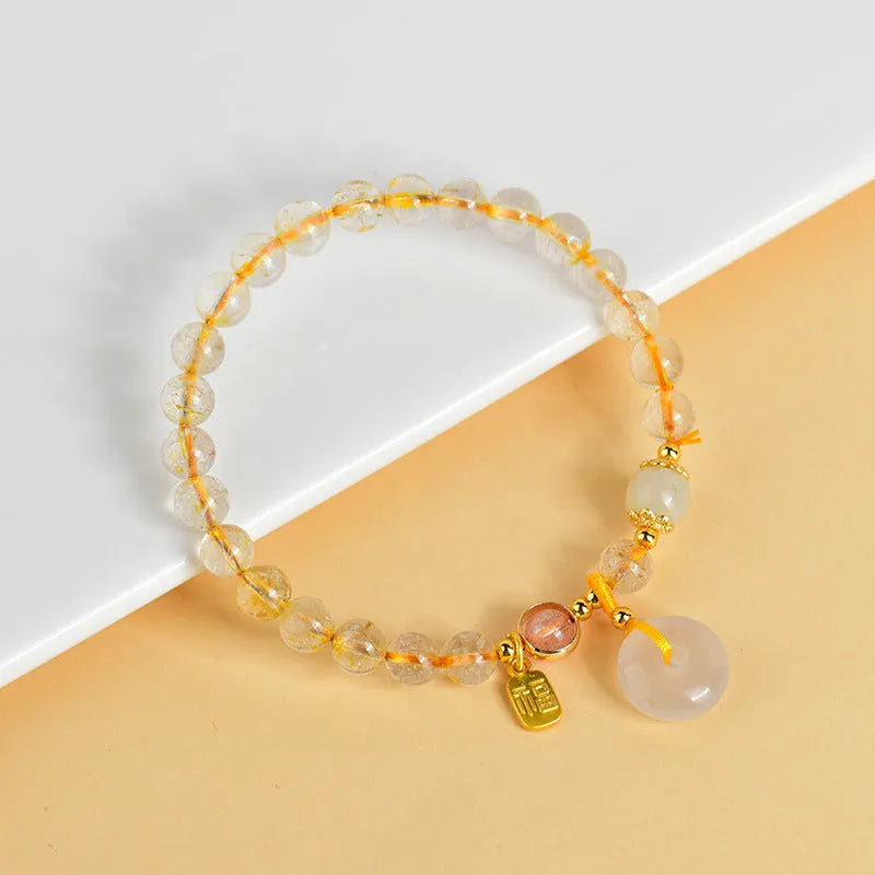 Gold rutilated quartz crystal bracelet with safety buckle and geometric blessing card pendant