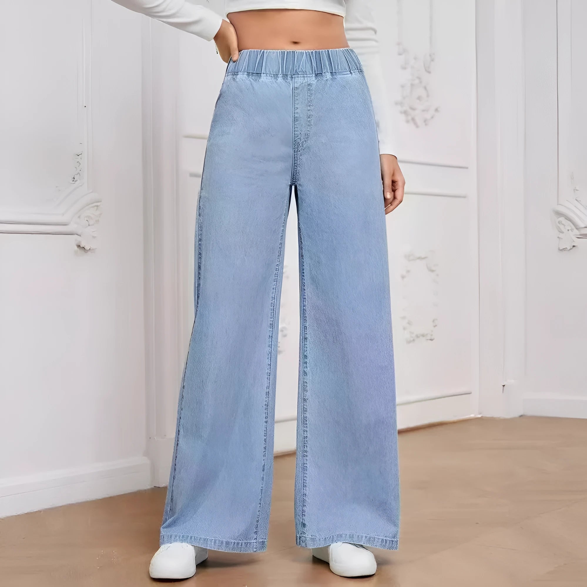 Light blue washed wide-leg straight-cut jeans on a hanger, showing mid-waist and zip fly detail.