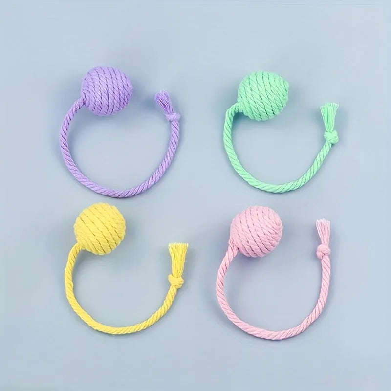 Fabric cat toy ball with rope attached in green, pink, purple, or yellow colours