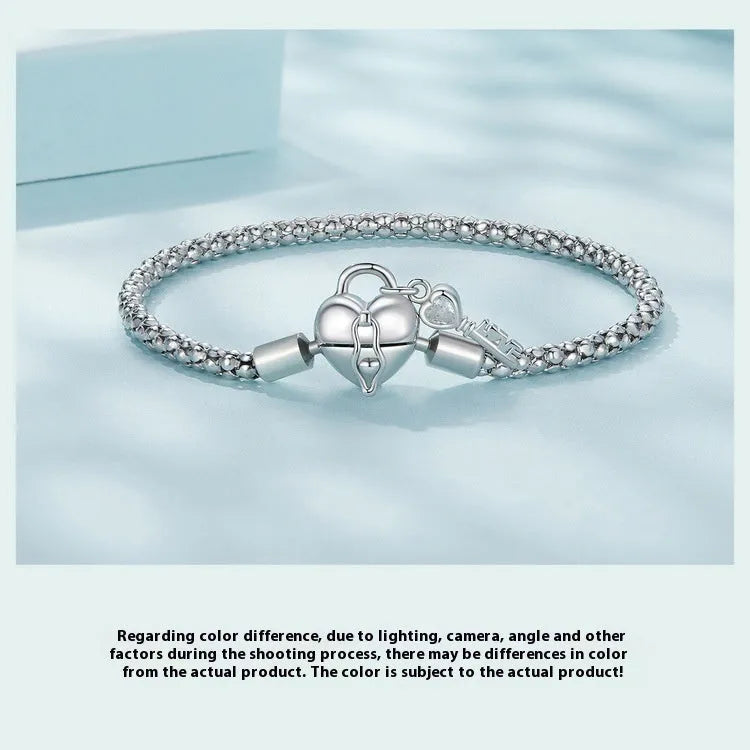 925 silver heart lock key bracelet with electroplated finish on neutral background