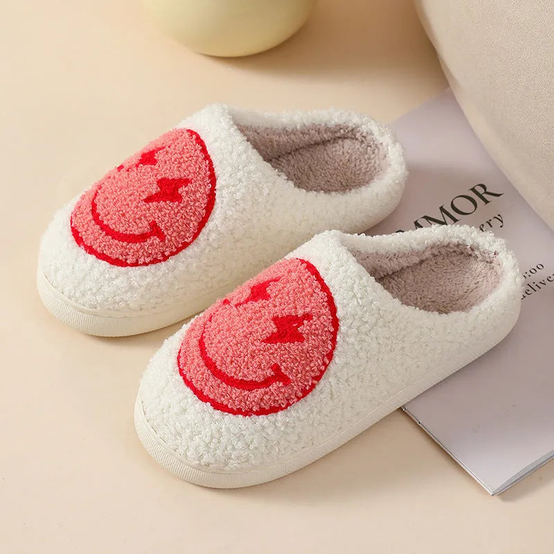 Women's plush slippers with cartoon love design, showing round toe and non-slip PVC sole.