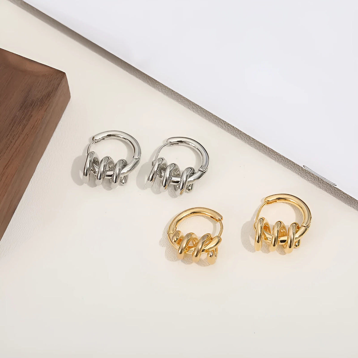 Spiral wound ear clip earrings in frosted geometric shape, copper with gold or silver plating, 1.75cm by 2.16cm.