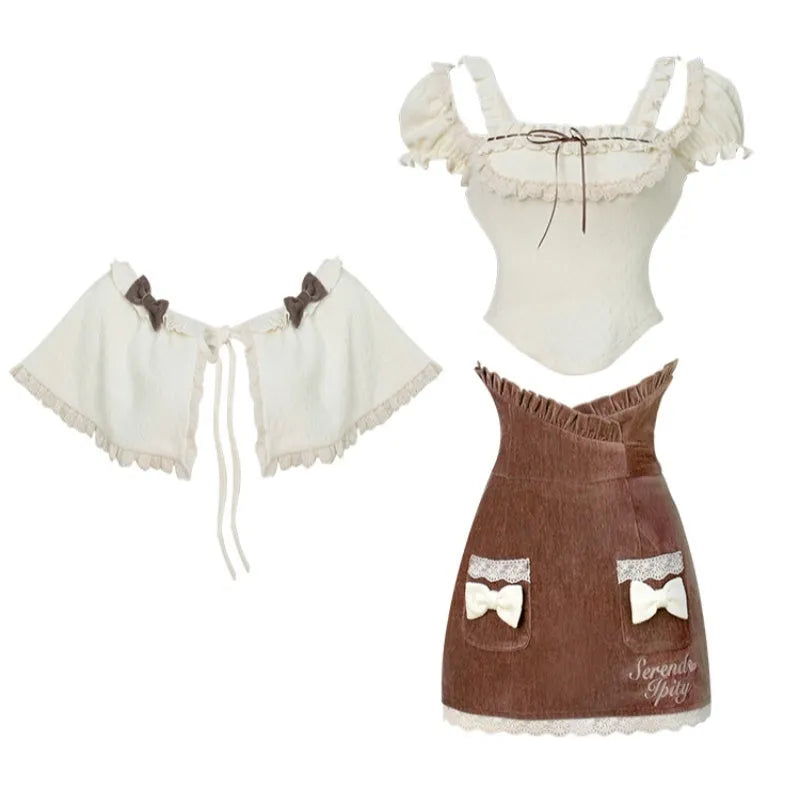 Three-piece apricot knitted top, brown hip skirt, and apricot shawl co-ord set on display