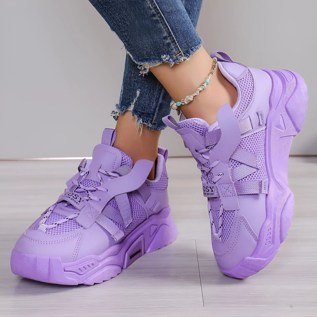 Women's purple platform mesh sports trainer with animal pattern and lace-up front.