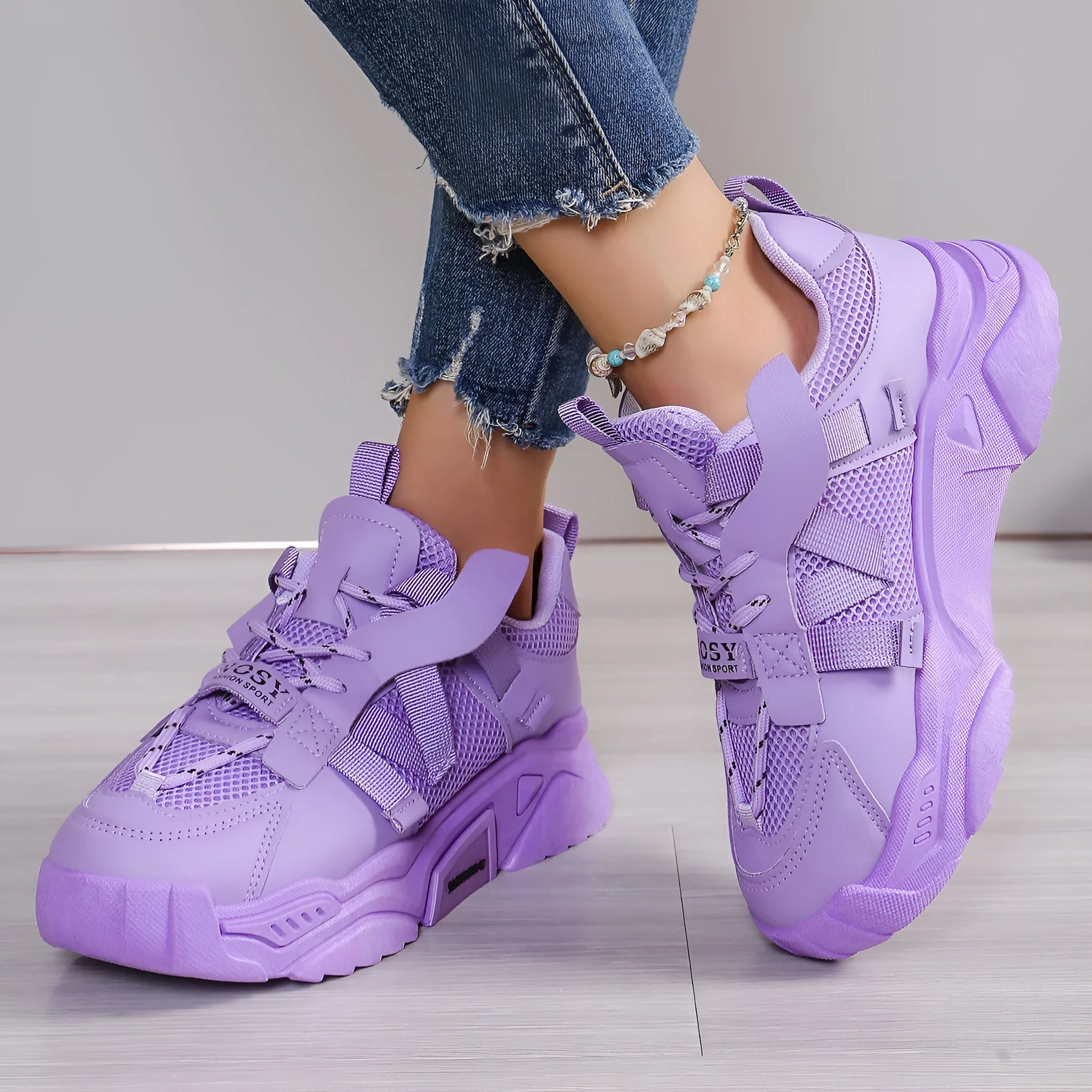 Women's purple platform mesh sports trainer with animal pattern and lace-up front.