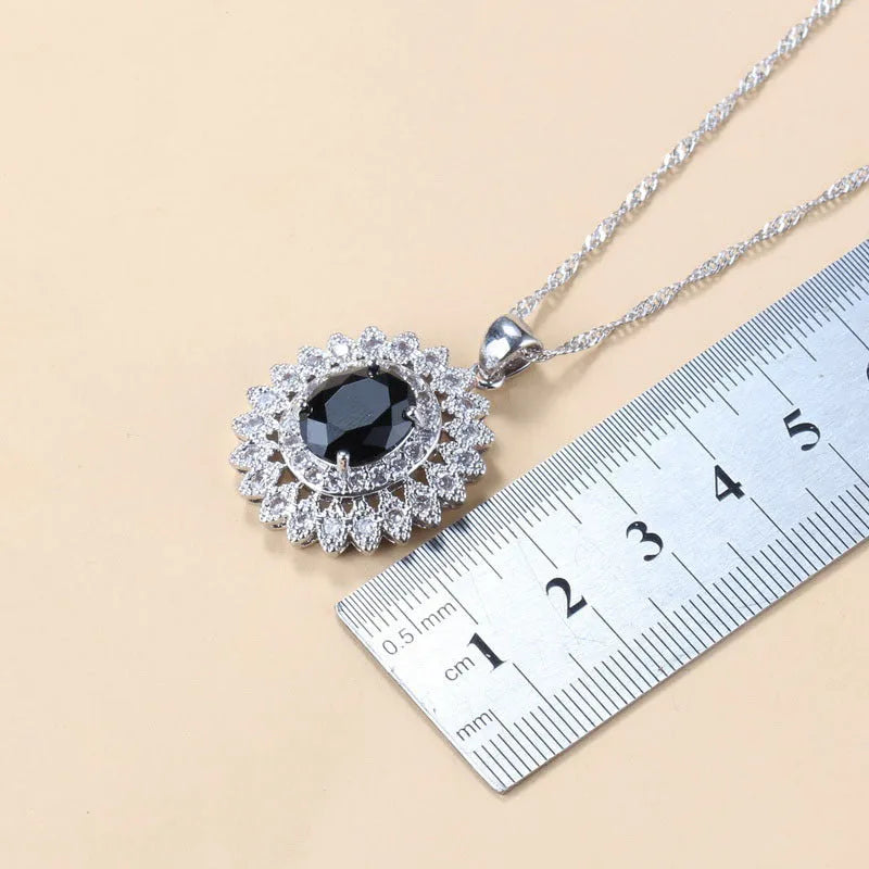 Garnet cubic zirconia four piece jewellery set including earrings necklace bracelet and ring with copper construction