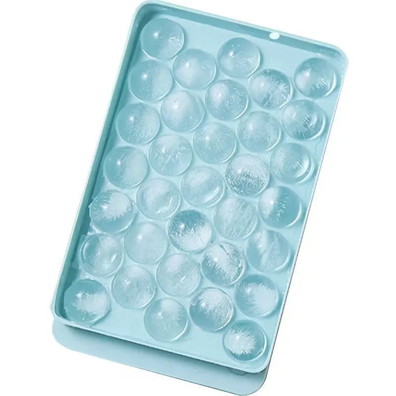 Silicone ice cube tray with lid in blue or pink, showing 33 round ice moulds measuring 24x14 cm.