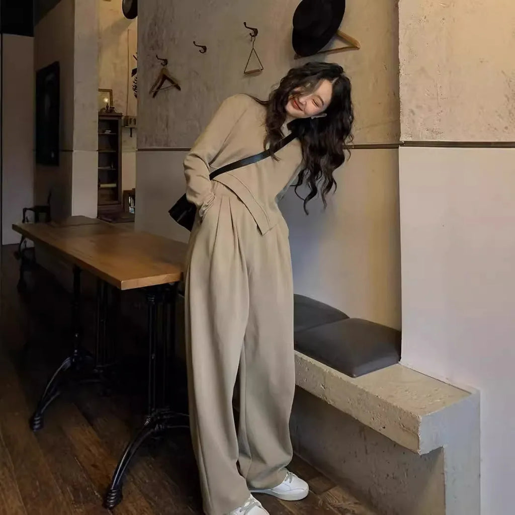 Women's loose khaki casual sports suit set with long sleeves and trousers on a hanger.