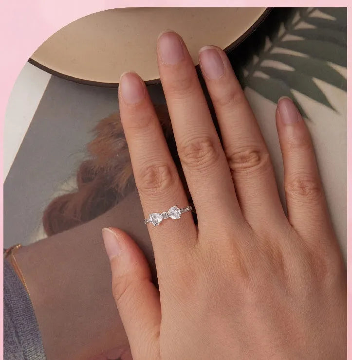 Sterling silver bow ring with zircon stone, available in sizes 6, 7, and 8, electroplated finish