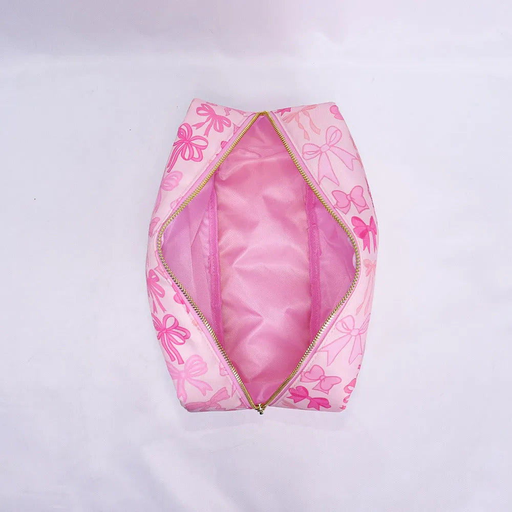 Printed nylon cosmetic bag in pink bow, pink stripes, blue or white with polyester lining and four sizes