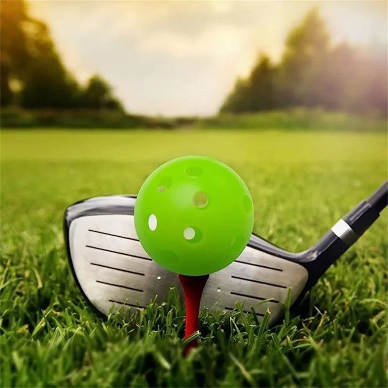 Assortment of red, orange, blue, green, white, and yellow 26-hole golf practice balls in a net bag.