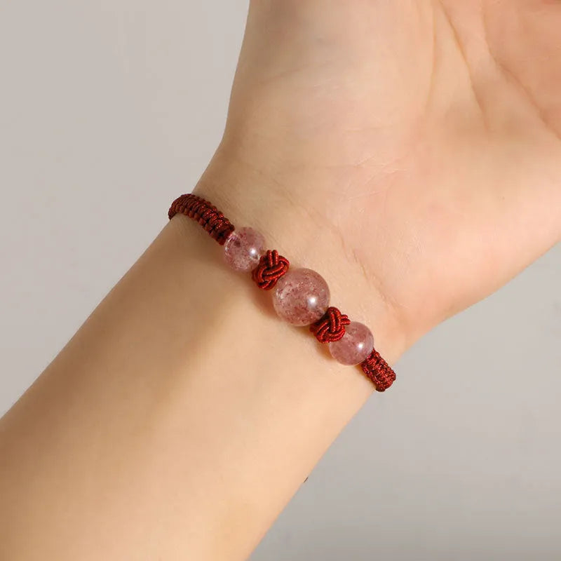 Natural strawberry quartz beaded bracelet on woven red rope with alloy clasp