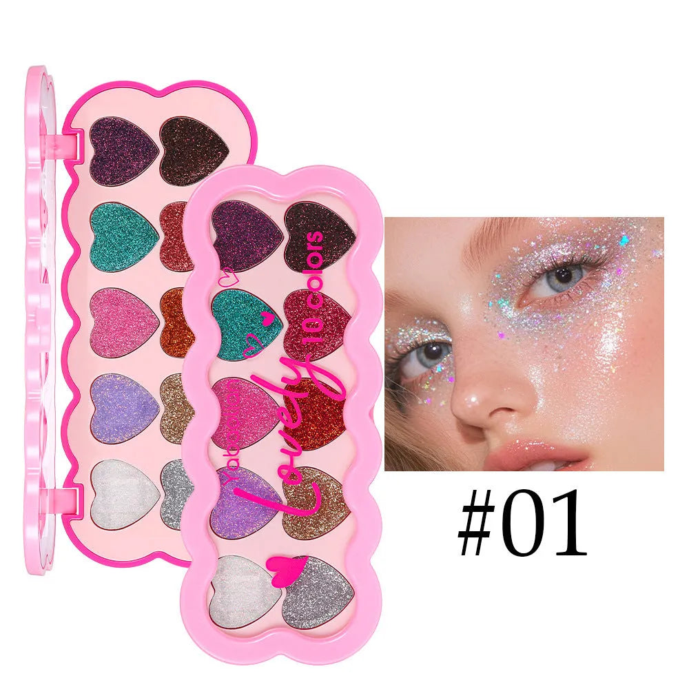 Heart-shaped compact open to show ten pans of pearlescent sequin eyeshadow in various colours.