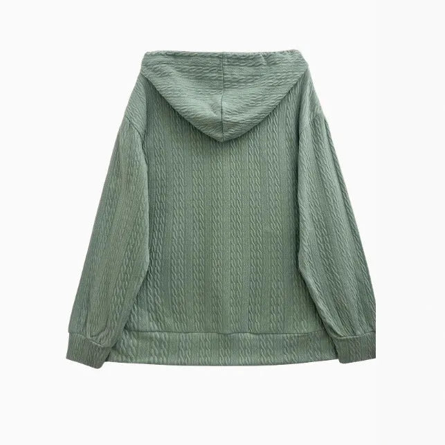 Forest green women's zip-up hooded sweater coat on a hanger, showing loose fit and long sleeves.