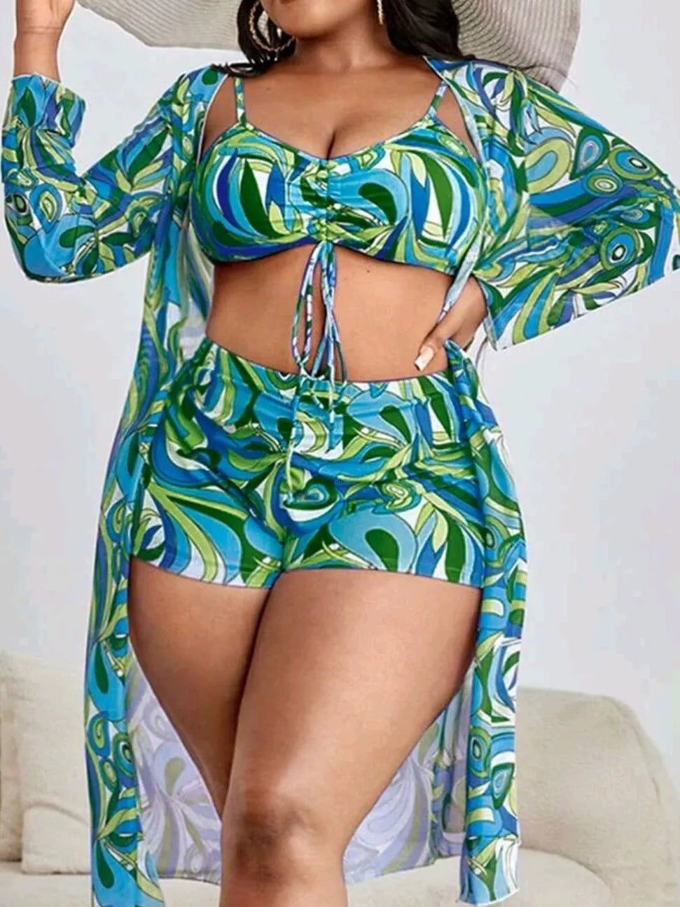 Women's floral print bikini three-piece set with bra, briefs, and cardigan cover-up.