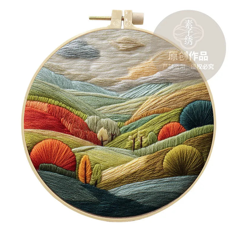 Embroidery DIY kit with cotton linen fabric, bamboo hoop, threads, and needles for landscape designs.