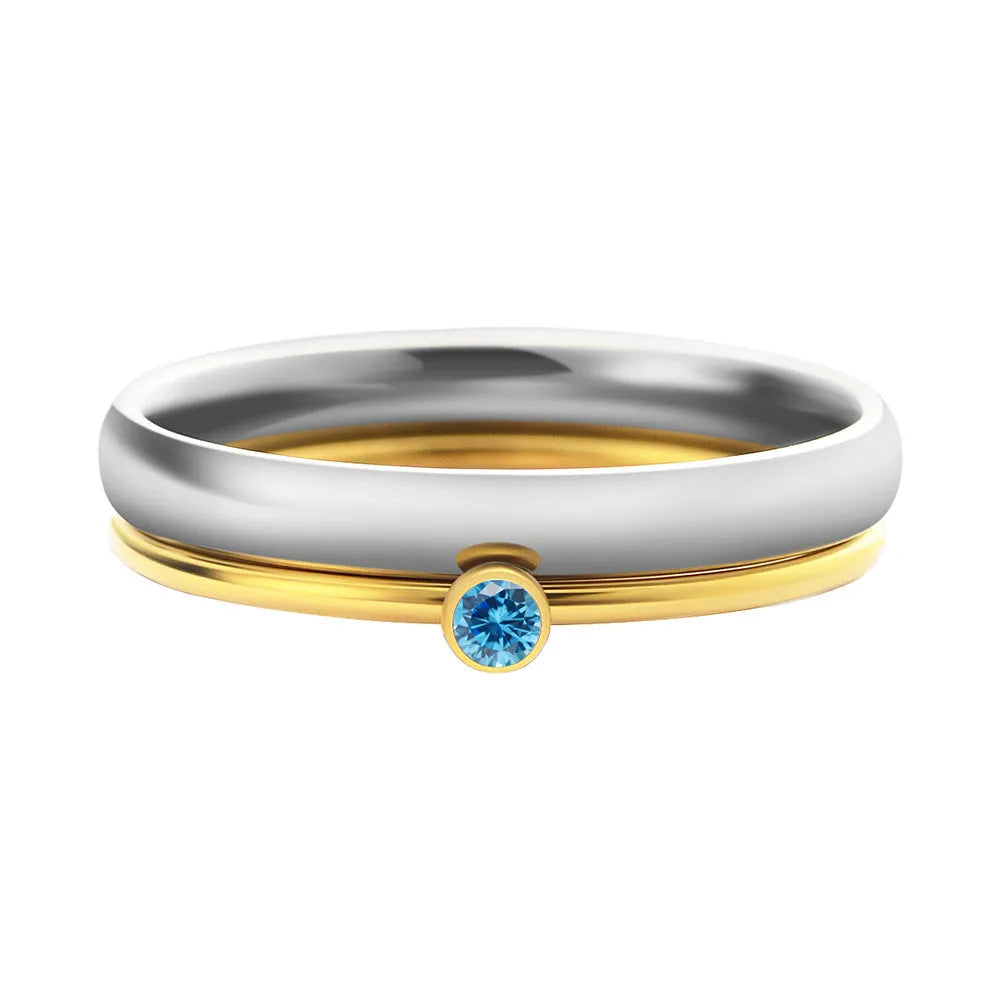 December birthstone engraved geometric ring in titanium steel with gold accents, shown on a finger.