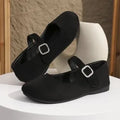Black canvas fisherman shoes with rubber sole showing low-top design