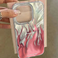Blue and red flame design on a black silicone iPhone case showing full edge coverage.