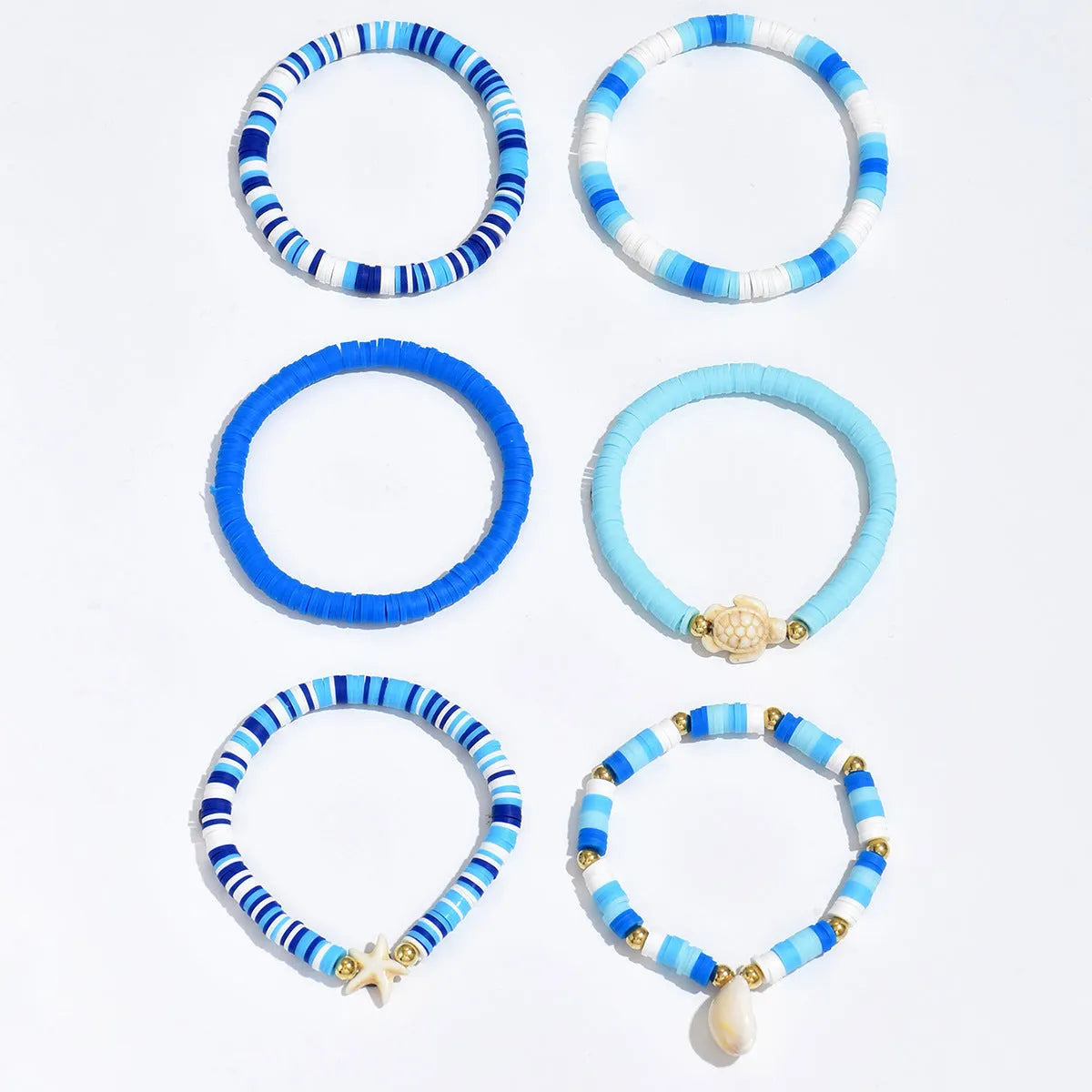 Set of six handmade geometric shell bracelets in Bohemian blue polymer clay.