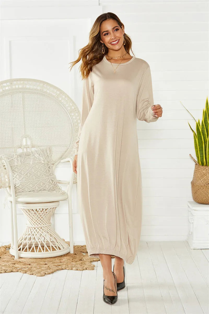 A loose black lantern dress with a lace-up crew neck, showcasing its casual knitted pullover style.