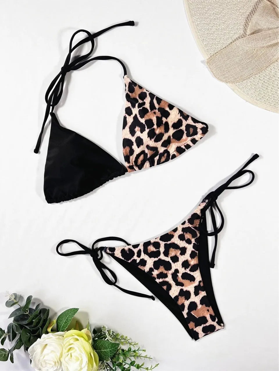 Red leopard print women's bikini with halter neck and lace-up front detail.