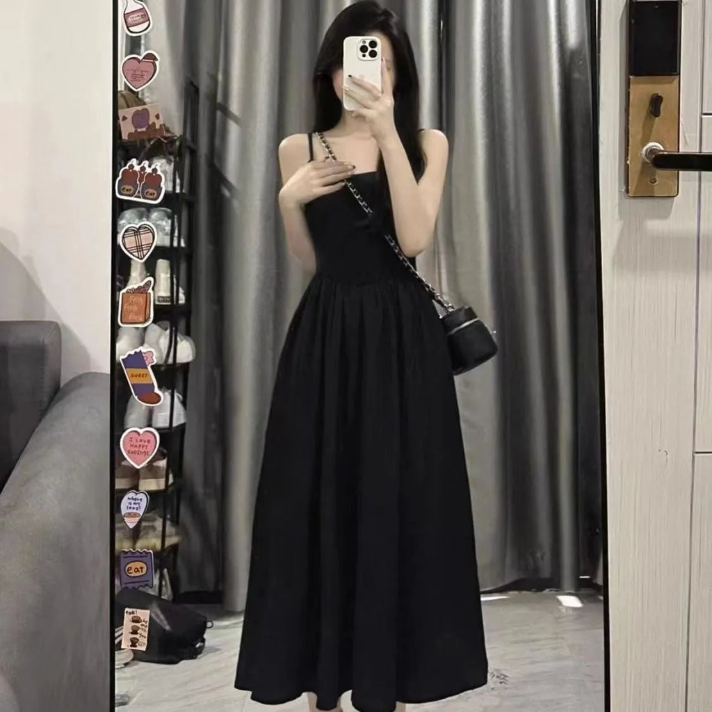 A-line slip dress in black with wide waist and sleeveless design made from polyester