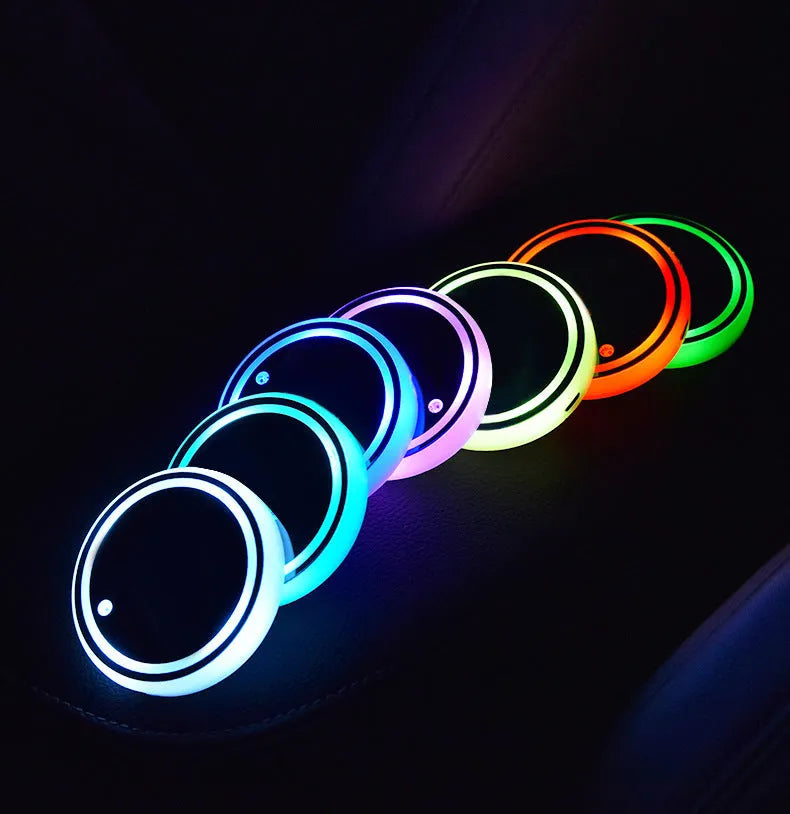 Colourful LED light-up coaster for car cup holder with USB cable, showing multiple light colours.
