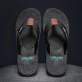 Men's black flip flops with non-slip sole and EVA upper on a beach background