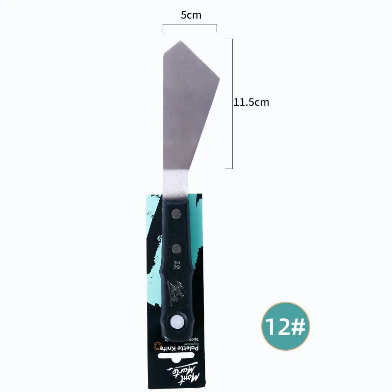 Three stainless steel artist palette knives with different blade sizes on a wooden table.