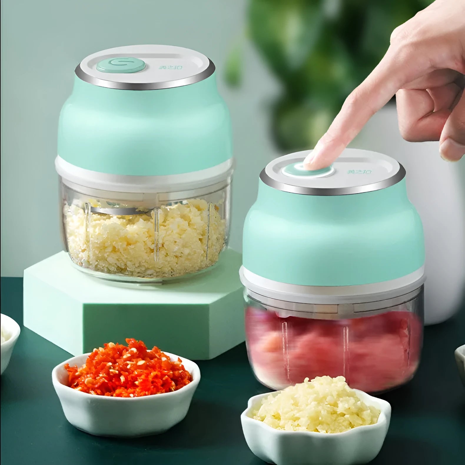 Portable USB electric food chopper with transparent cup and stainless steel blade.