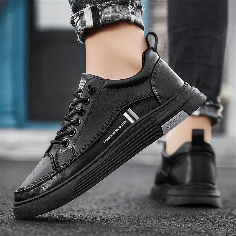 Men's low-top skate shoes in black with a round toe, elastic band, and rubber sole.