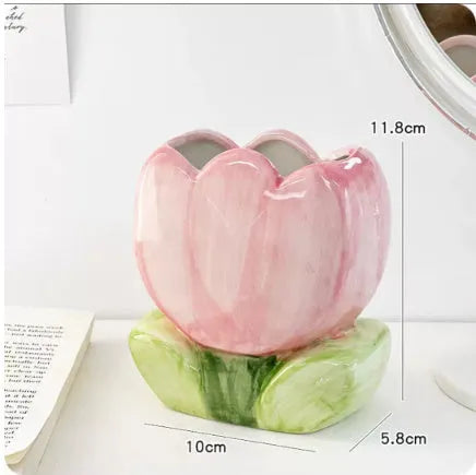 Ceramic flower pen holder in a floral pattern, showing its size next to pens for scale.