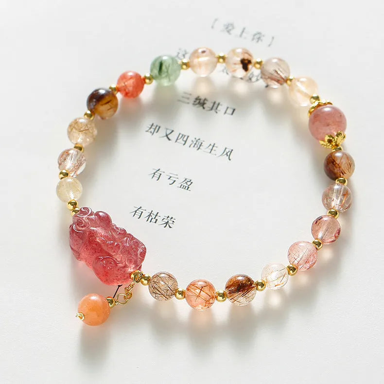Women's strawberry quartz and copper bracelet with Pixiu charm, pearl, and dopamine crystals.