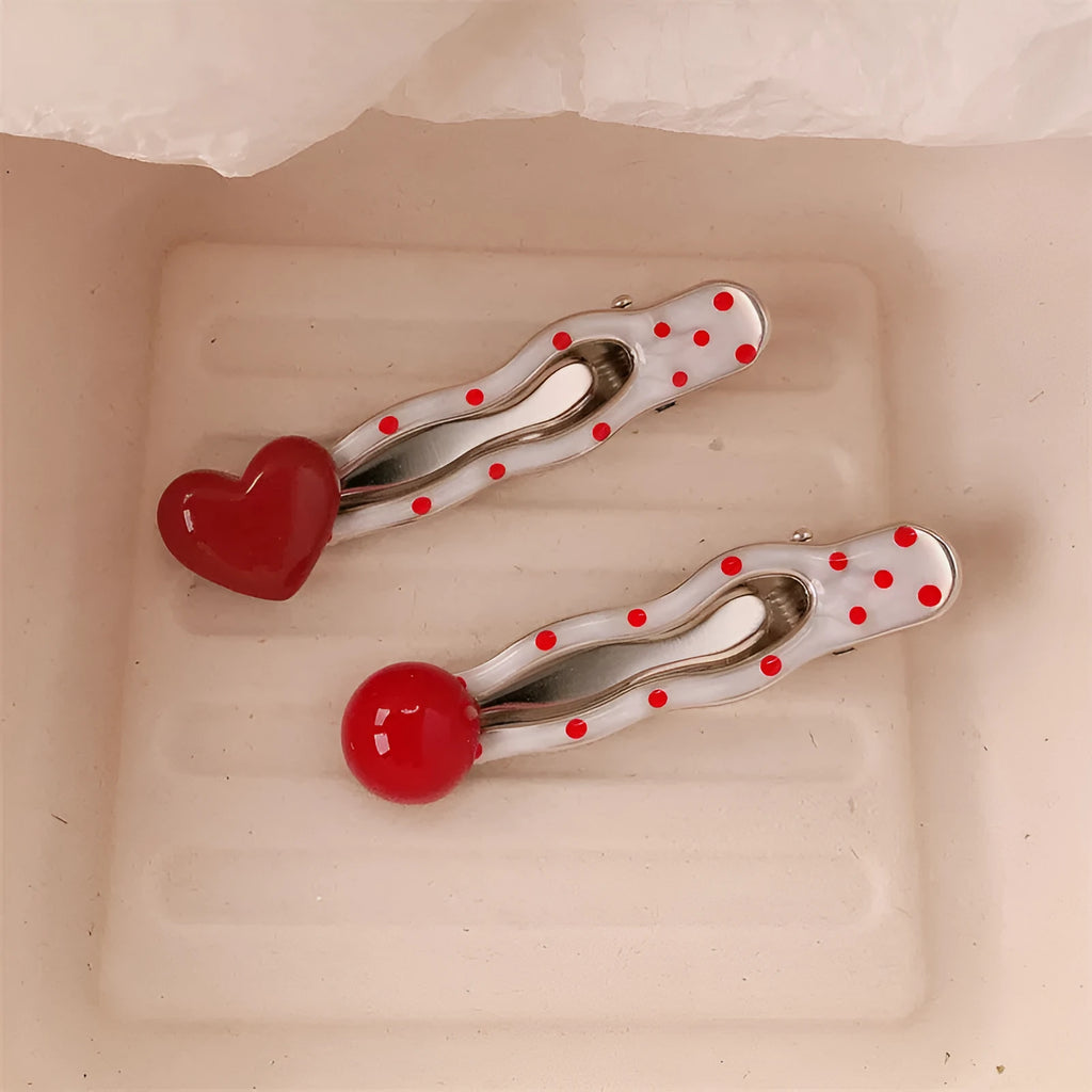 Red love heart shaped barrette hair clip with retro white dot design on black background