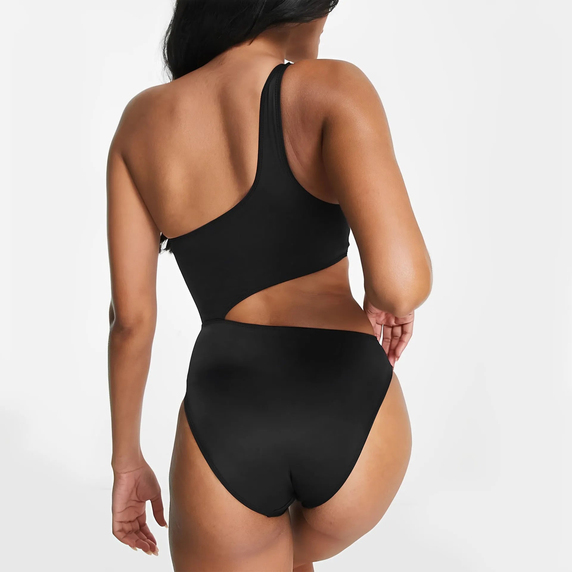 Black women's one-piece swimsuit with white contrast stitching and hollow cut-out design on a mannequin