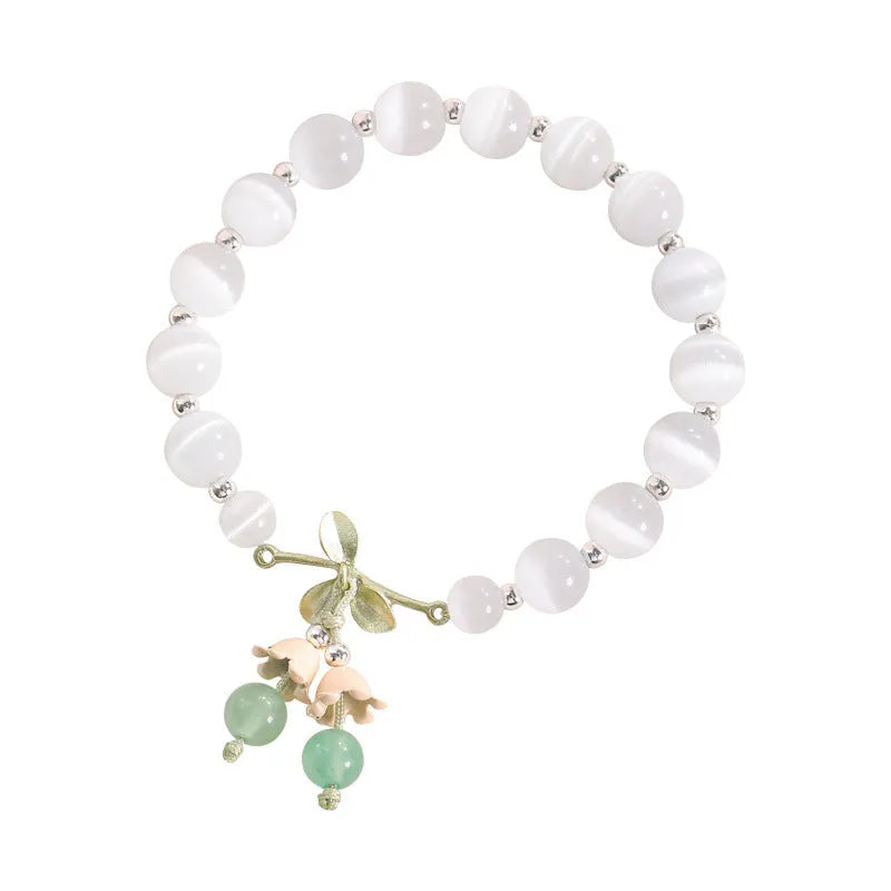 Women's beaded bracelet with diamond-shaped cat's eye opal stones in multiple colour options on a wrist.